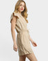 Woman wearing a beige dress on a white background