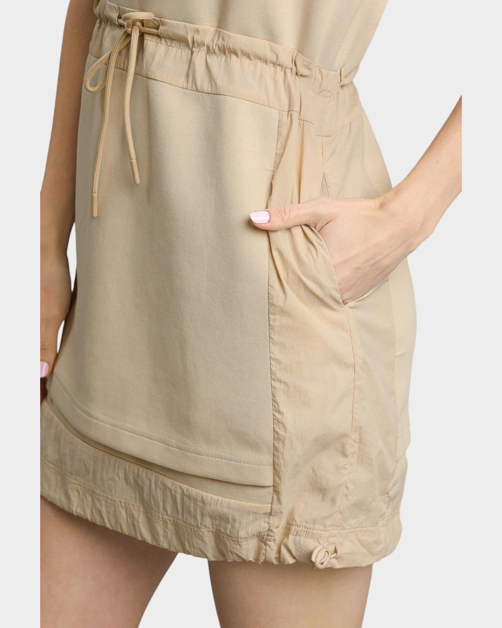 Beige dress with a tie waist and front pocket on a white background