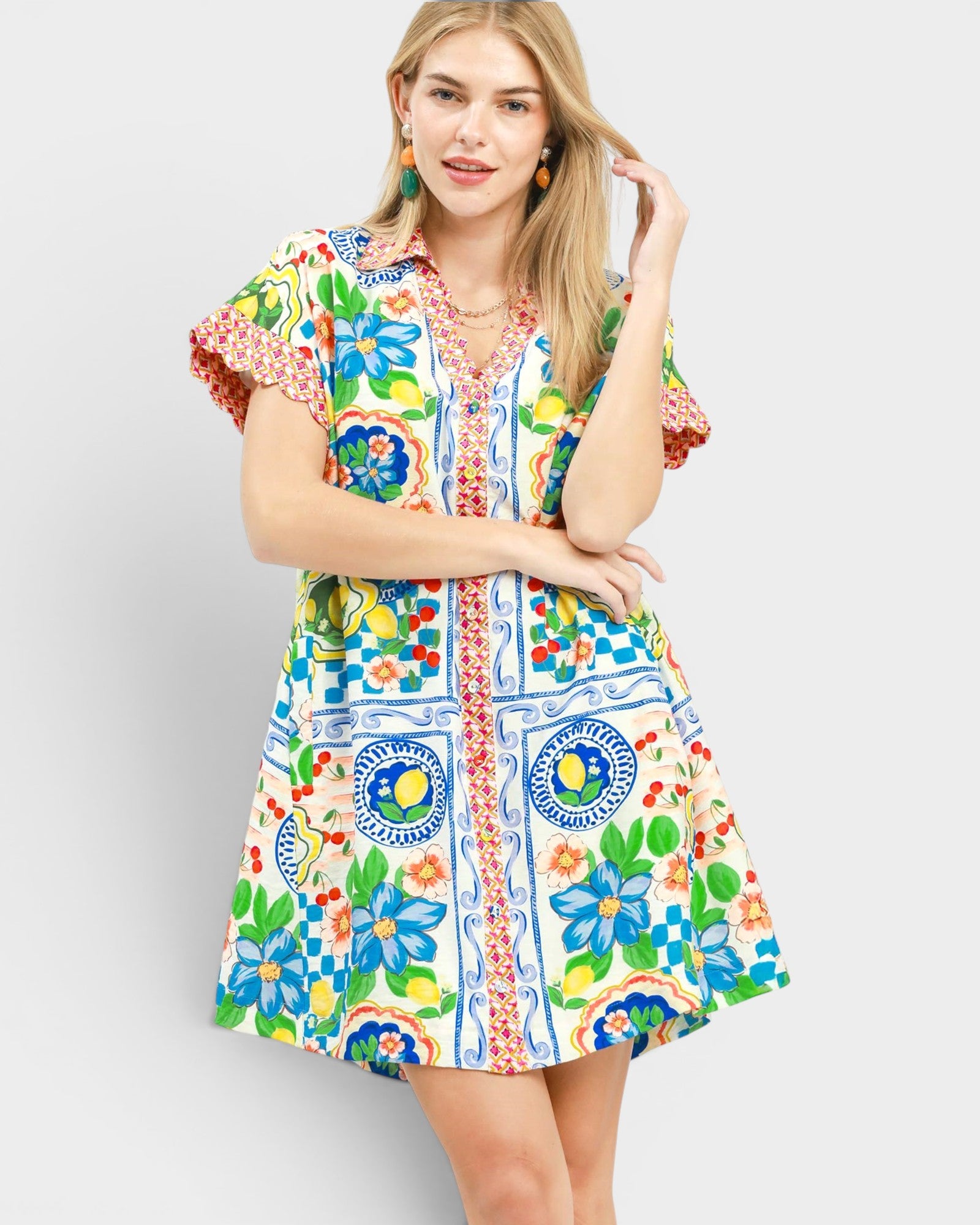 Woman wearing a colorful patterned dress on a plain background