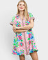 Woman wearing a colorful patterned dress on a white background