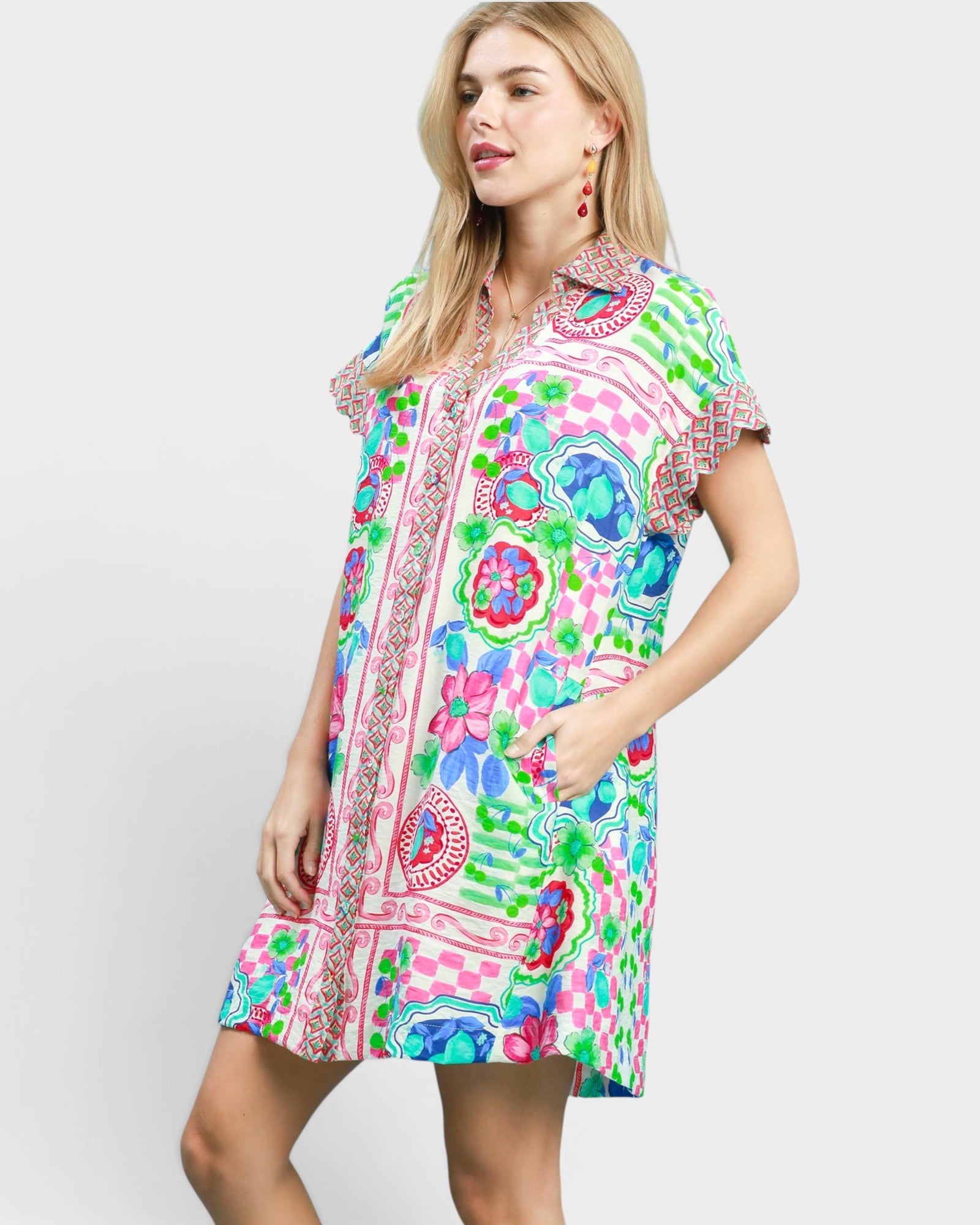 Woman wearing a colorful patterned dress on a white background