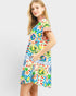 Woman wearing a colorful patterned dress on a white background