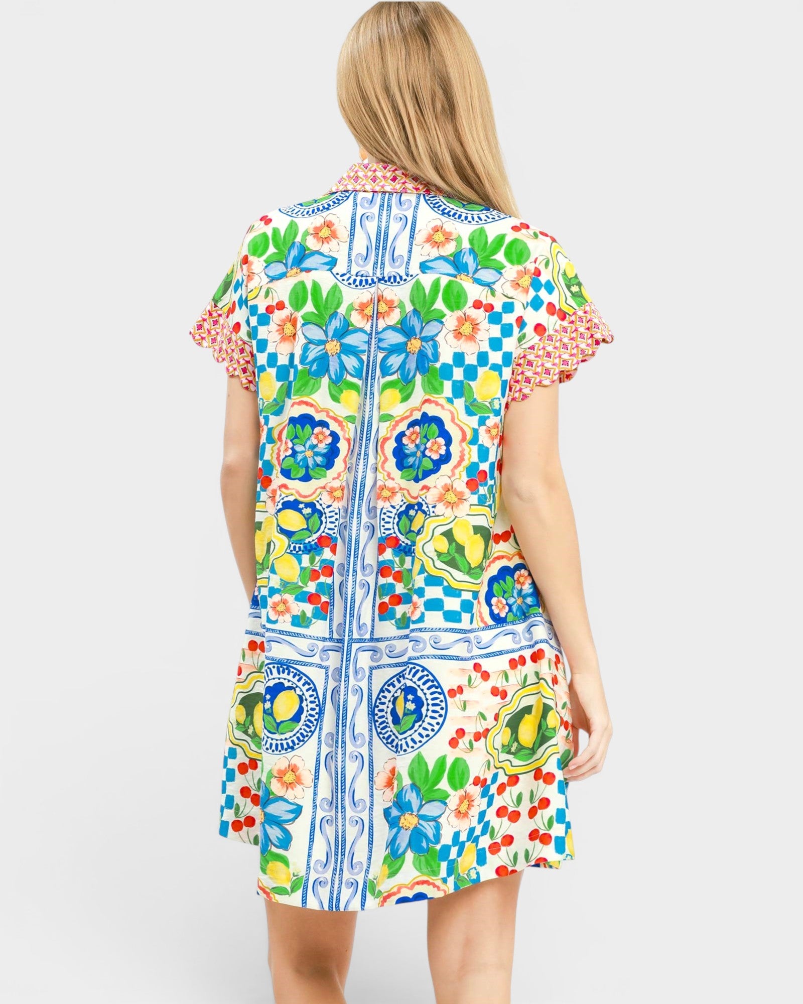 Woman wearing a colorful patterned dress on a white background