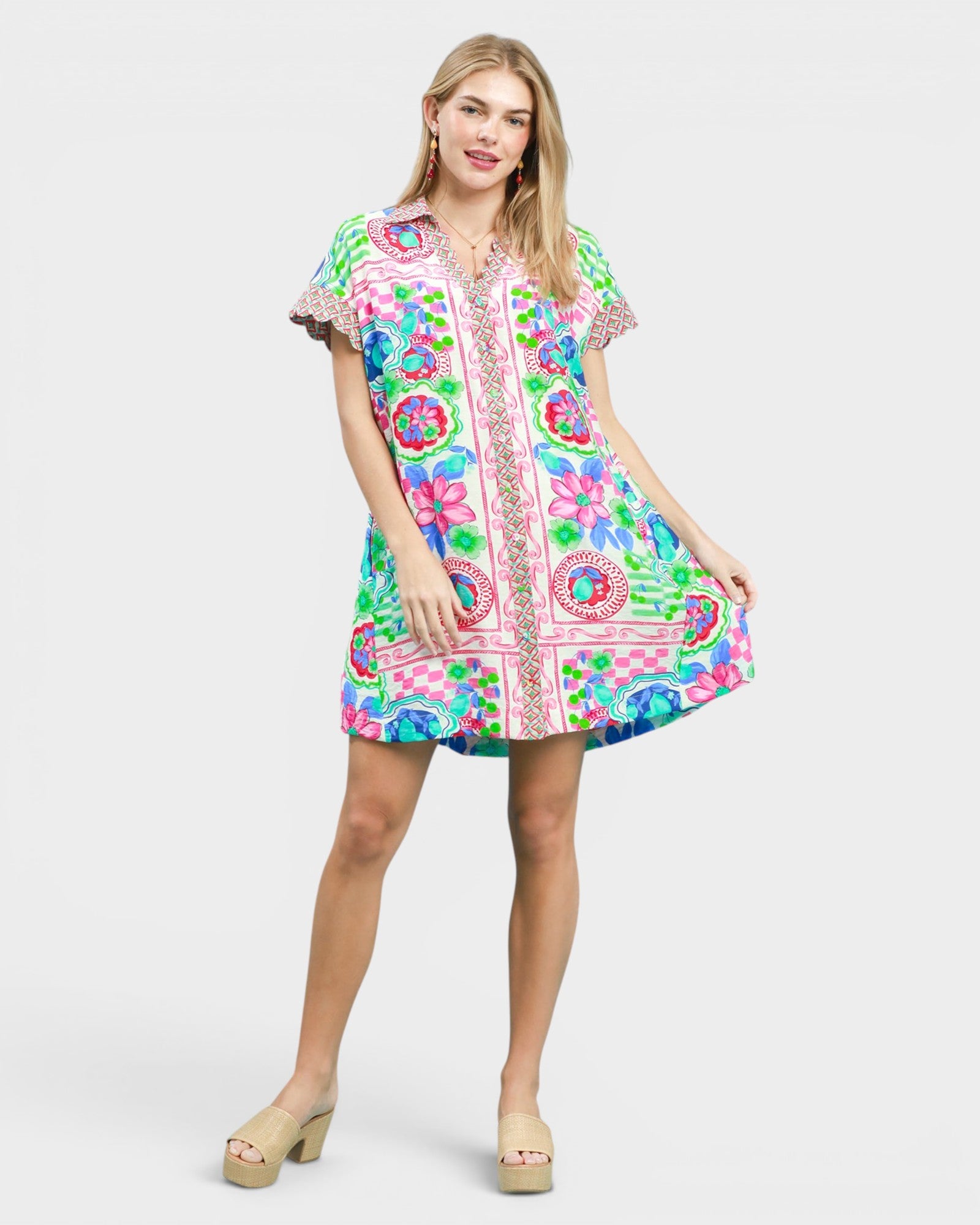 Woman wearing a colorful patterned dress on a white background