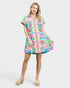 Woman wearing a colorful patterned dress on a white background