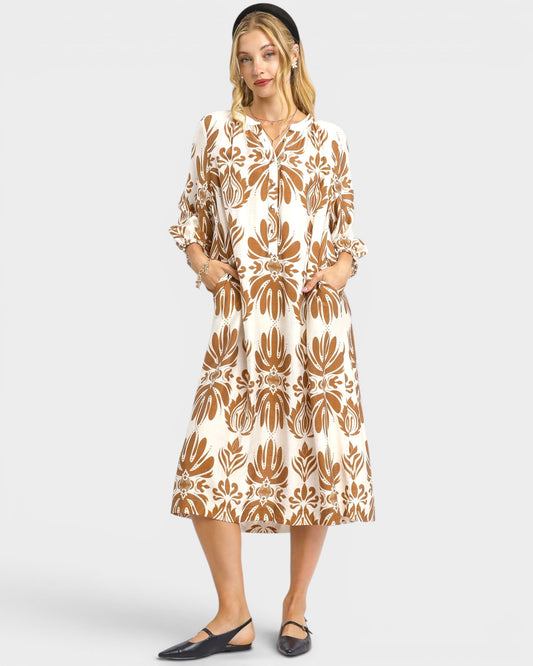 Woman wearing a patterned dress on a white background