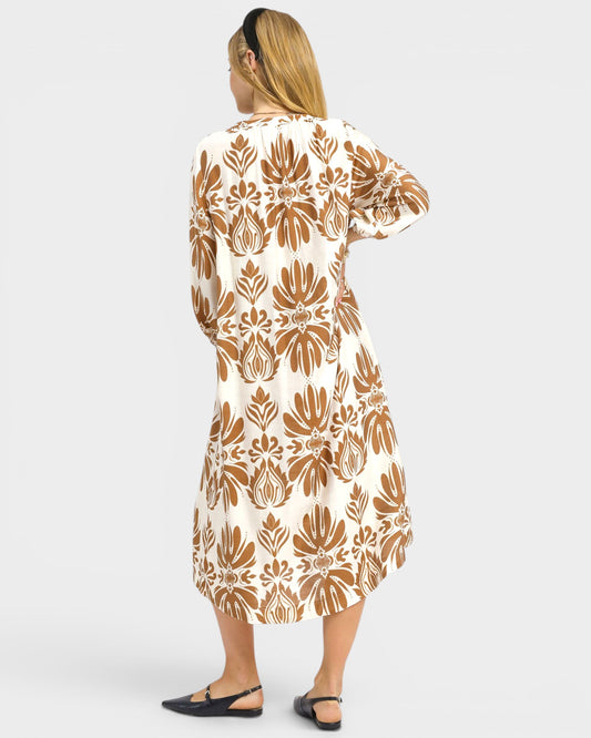 Woman wearing a patterned dress on a white background