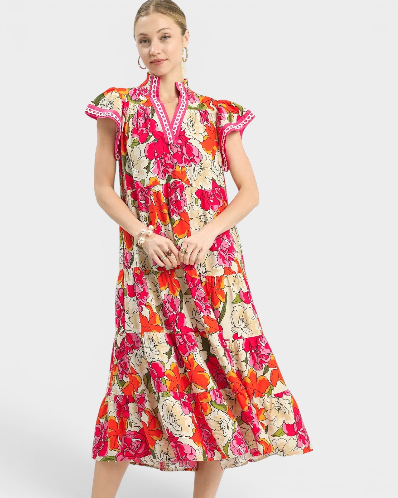 Woman wearing a colorful floral dress on a white background