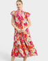Woman wearing a colorful floral dress on a white background
