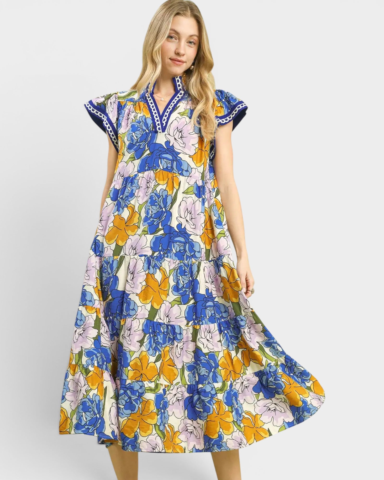 Woman wearing a colorful floral dress on a white background