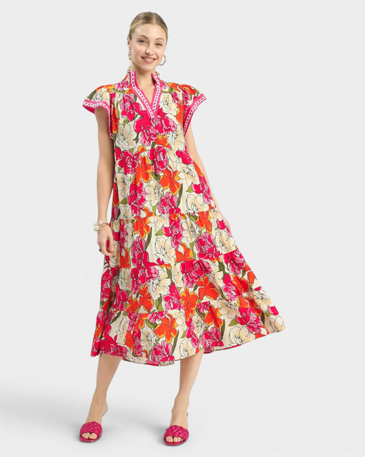 Woman wearing a colorful floral dress on a white background