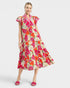 Woman wearing a colorful floral dress on a white background