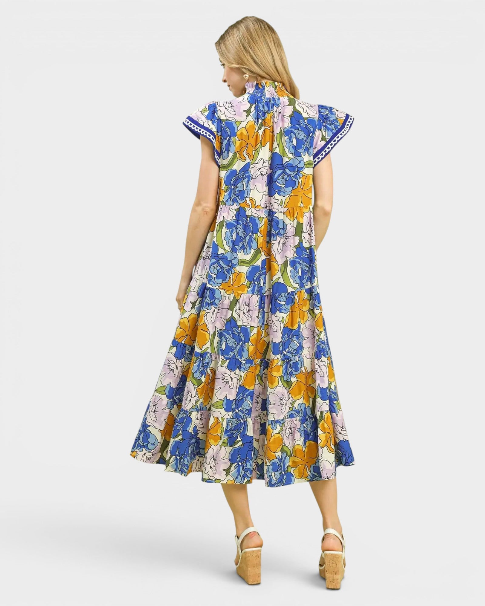 Woman wearing a colorful floral dress on a white background