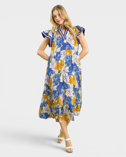 Woman wearing a colorful floral dress on a white background