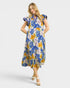 Woman wearing a colorful floral dress on a white background