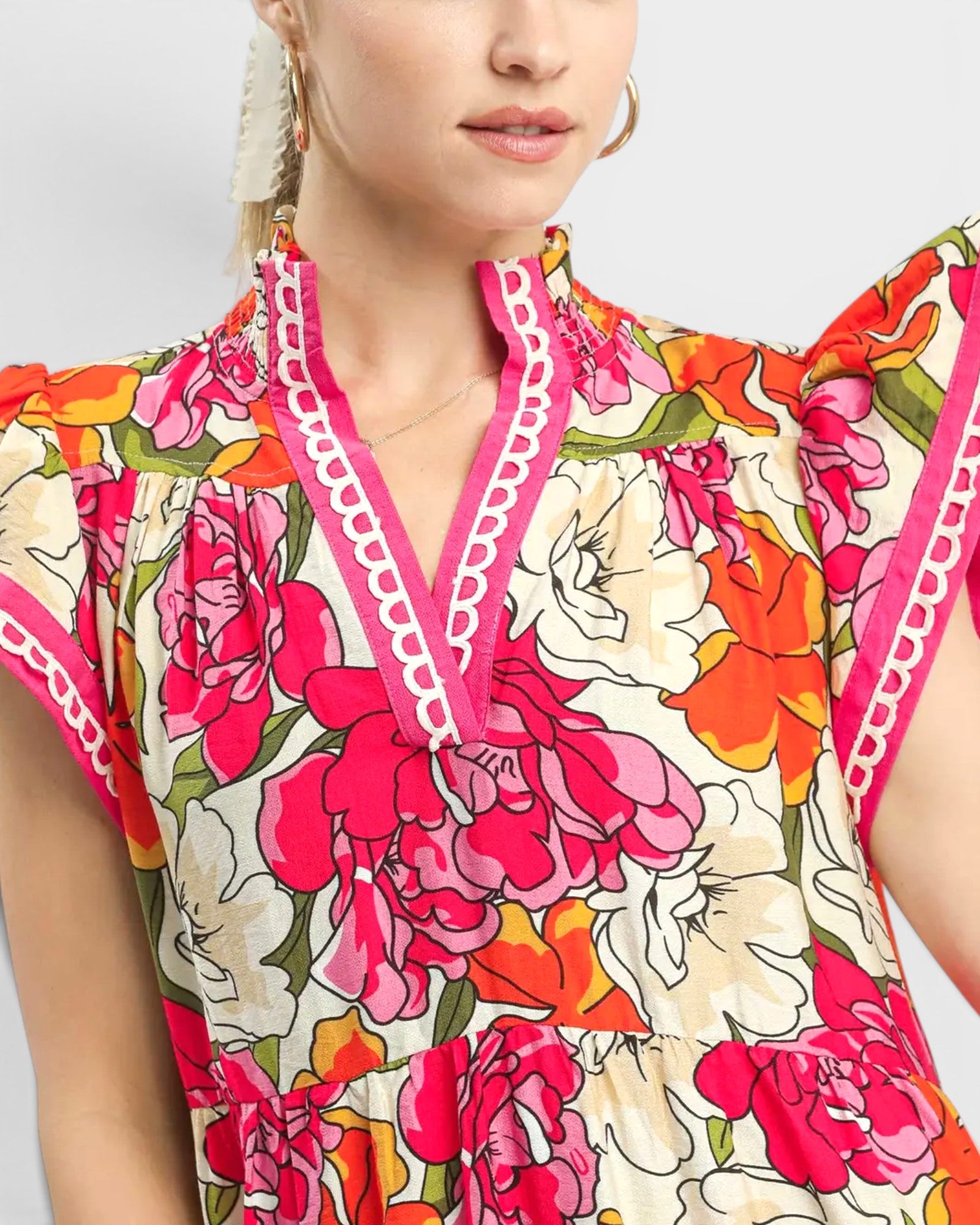 Woman wearing a colorful floral dress with a white background