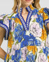 Close-up of a colorful floral dress with blue accents