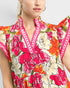 Woman wearing a colorful floral dress with a white background