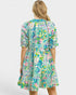 Woman wearing a colorful floral dress on a white background