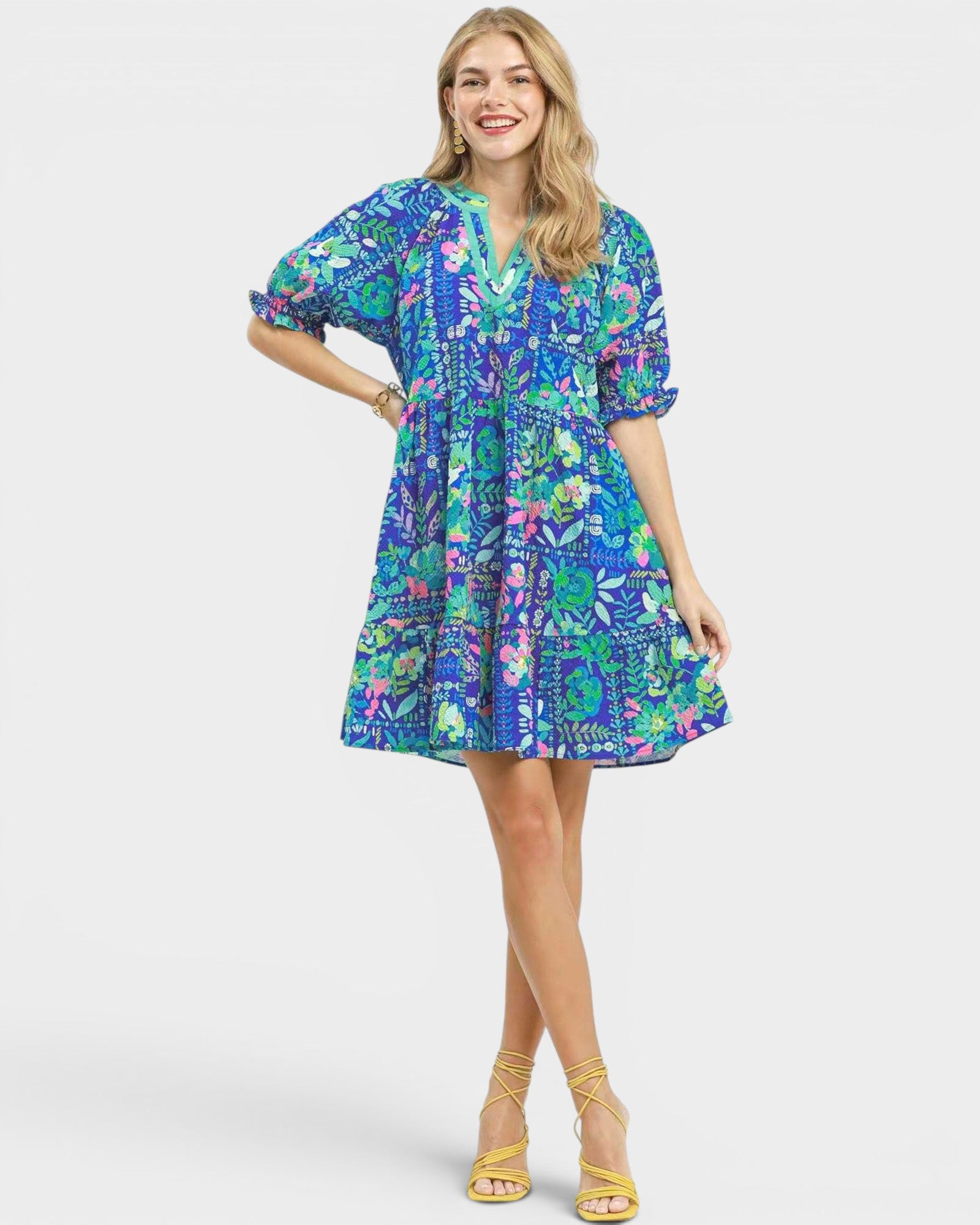 Woman wearing a colorful patterned dress on a white background