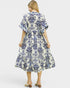 Woman wearing a blue and white patterned dress on a white background