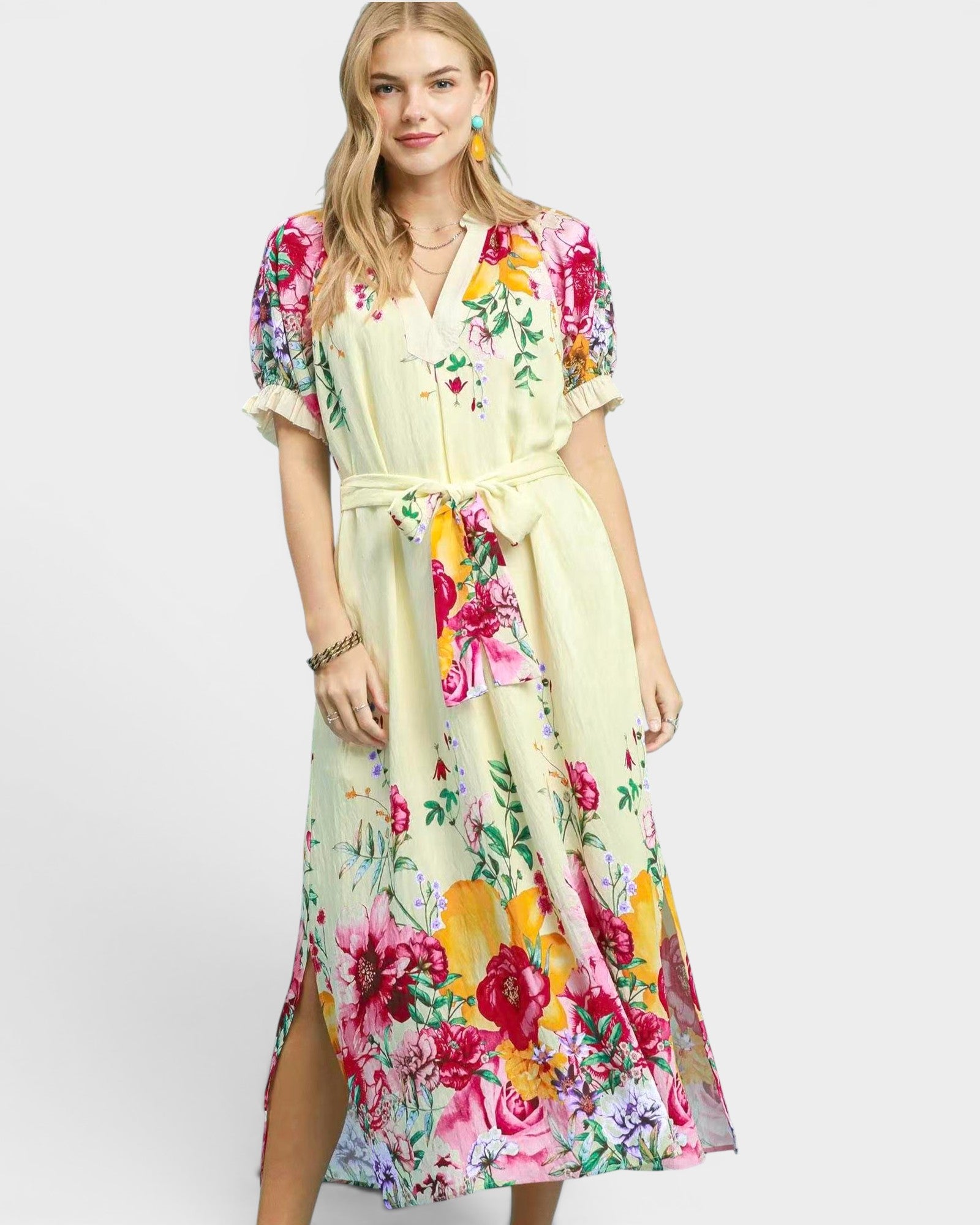 Woman wearing a colorful floral dress on a white background
