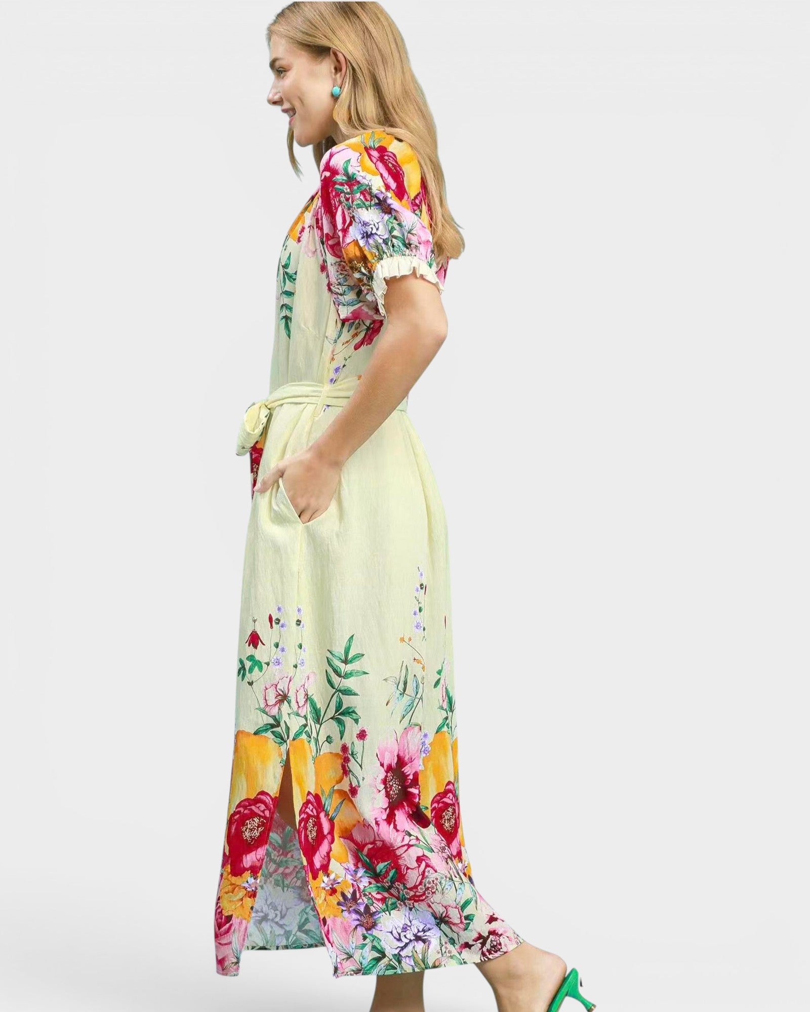 Woman wearing a colorful floral dress on a light gray background
