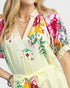 Woman wearing a floral dress with a white background