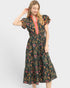 Woman wearing a floral dress with a colorful pattern on a white background