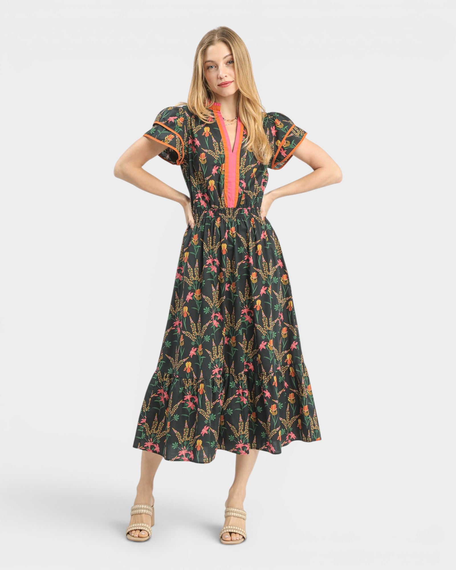 Woman wearing a floral dress with a colorful pattern on a white background