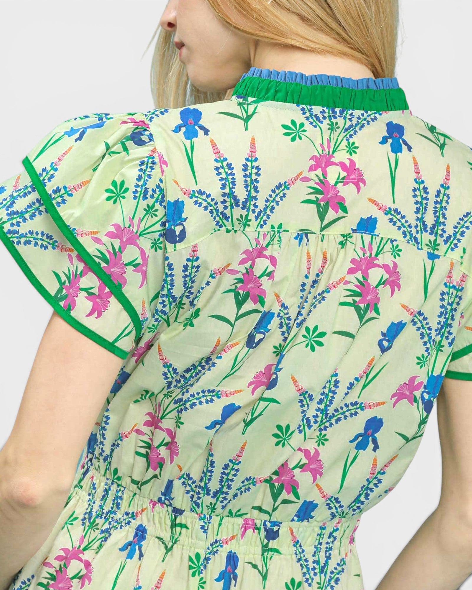 Woman wearing a floral dress with a white background