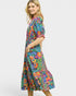 Woman wearing a colorful floral dress on a white background