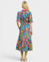 Woman wearing a colorful floral dress on a white background