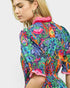 Woman wearing a colorful floral dress with a white background