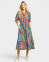 Woman wearing a colorful patterned dress on a white background