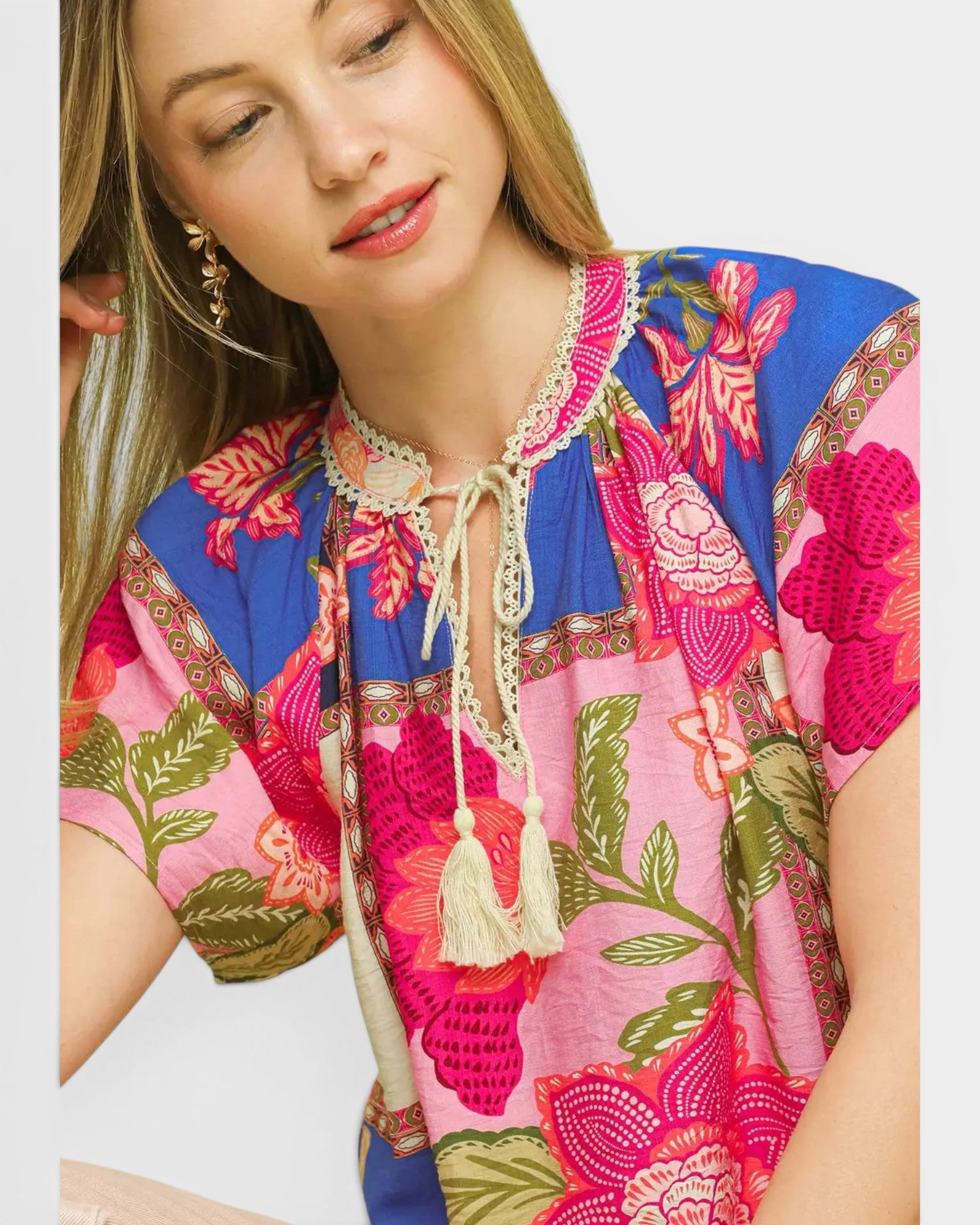 Woman wearing a colorful floral dress with a white background