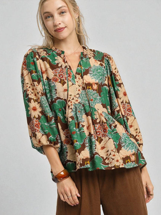 Woman wearing a floral blouse with a plain background