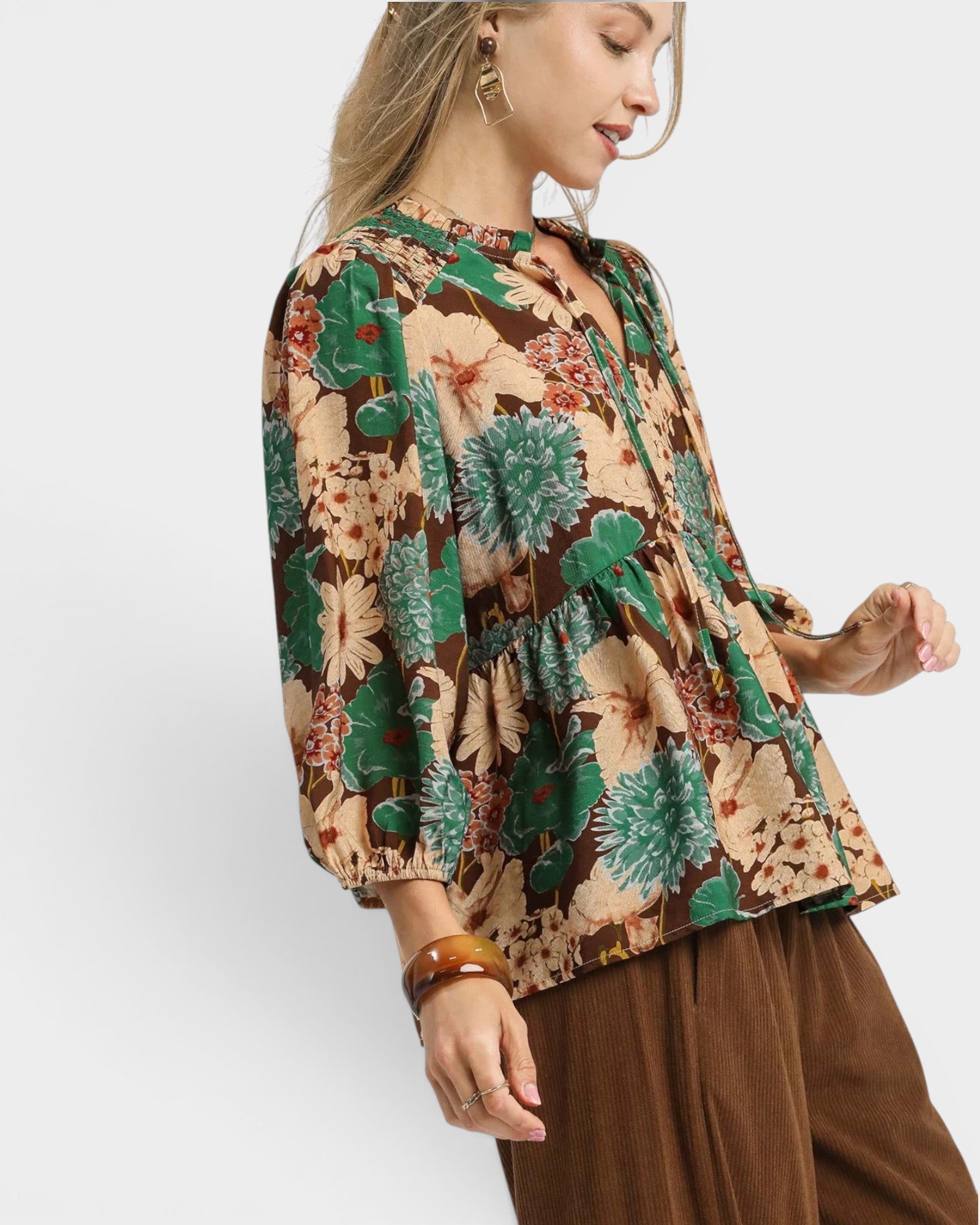 Woman wearing a floral blouse with a white background