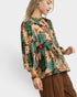 Woman wearing a floral blouse with a white background