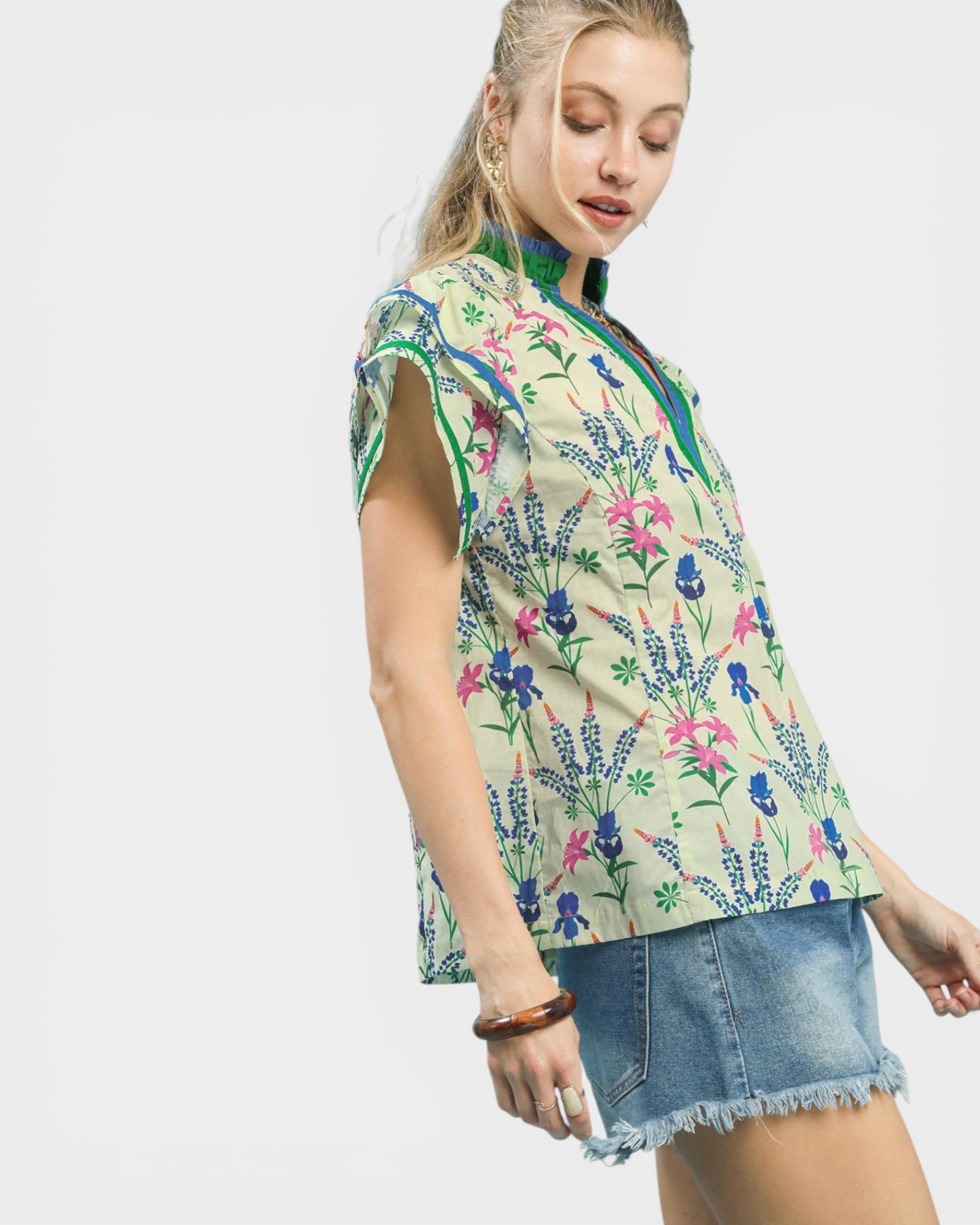 Woman wearing a floral blouse with a plain background