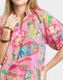 Person wearing a colorful pink kimono-style garment with butterfly patterns on a white background