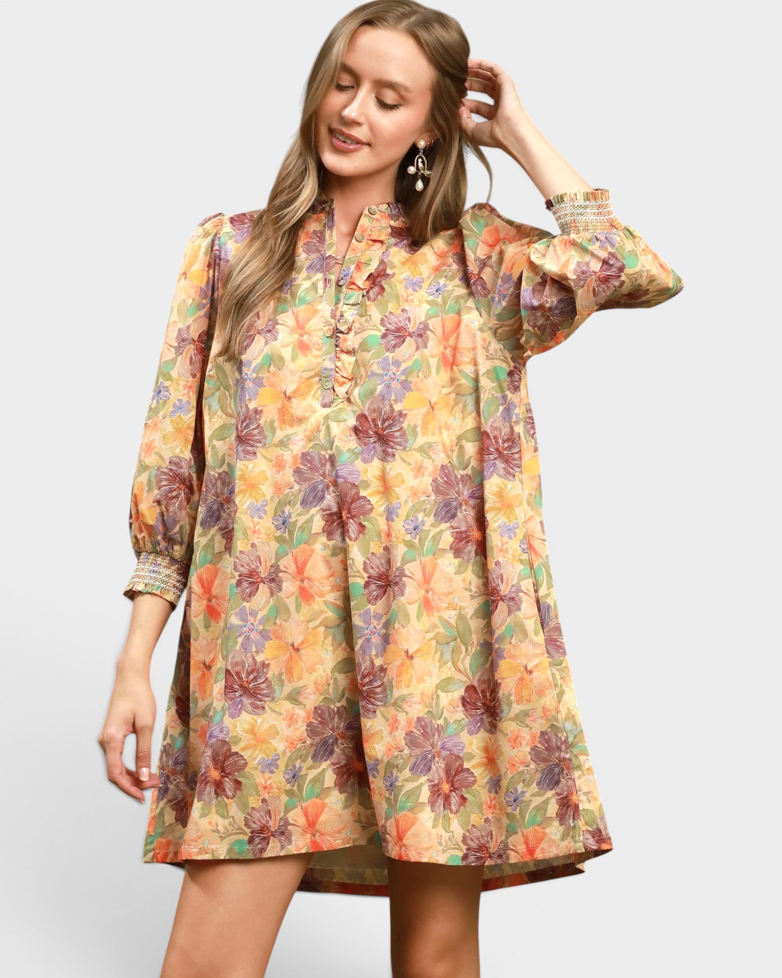 Woman wearing a floral dress on a plain background