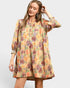 Woman wearing a floral dress on a plain background
