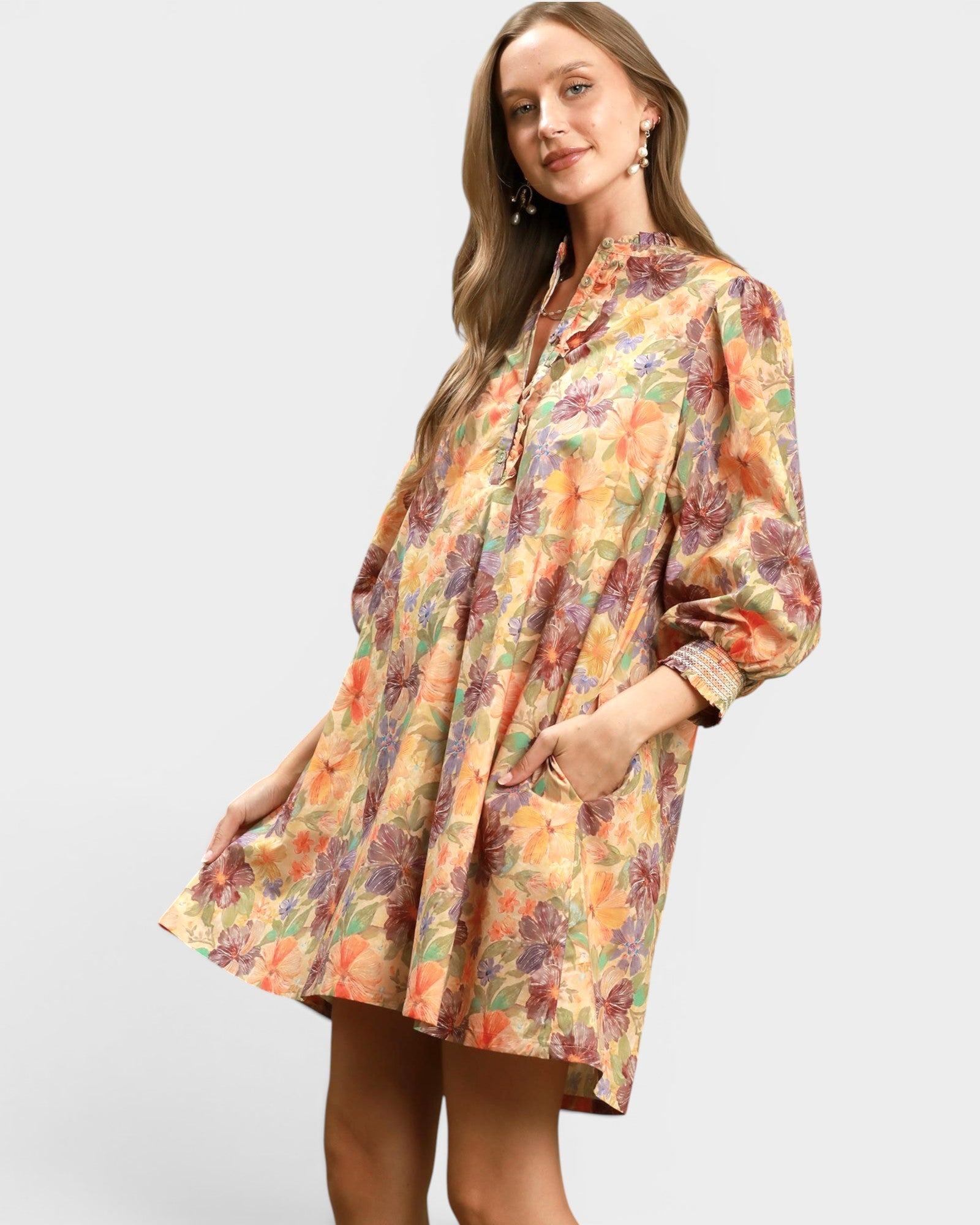 Woman wearing a floral dress on a plain background
