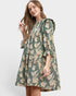 Woman wearing a green floral dress on a white background