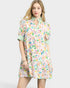 Woman wearing a floral dress with a plain background