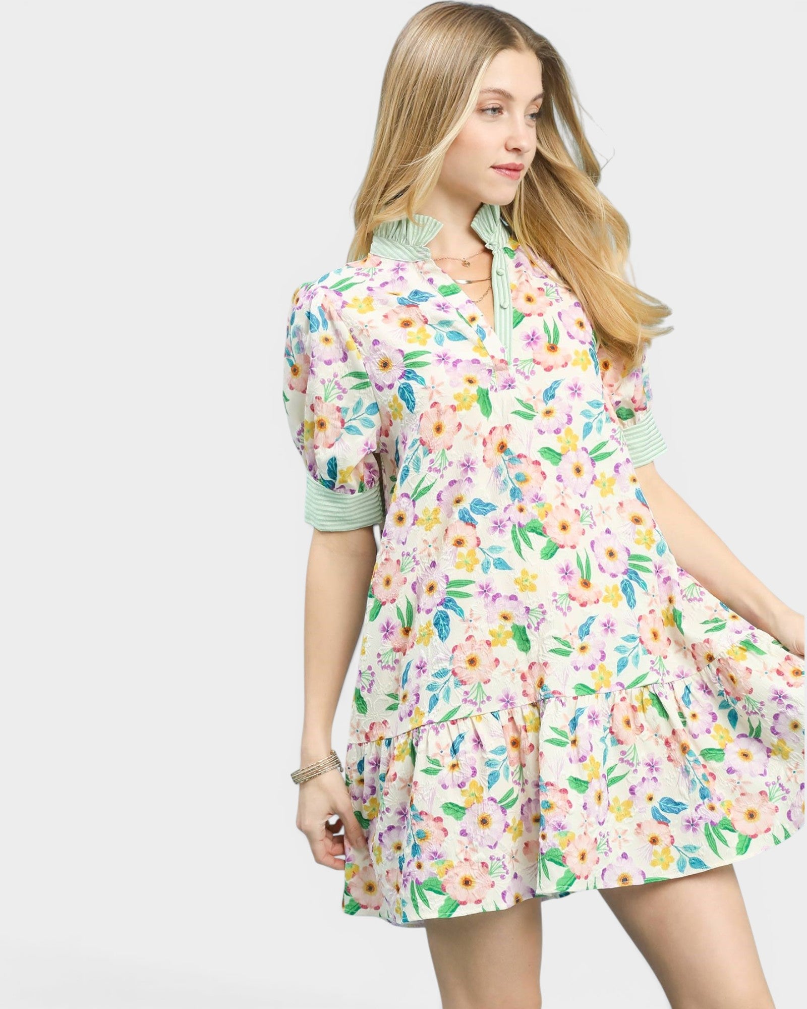 Woman wearing a colorful floral dress on a white background