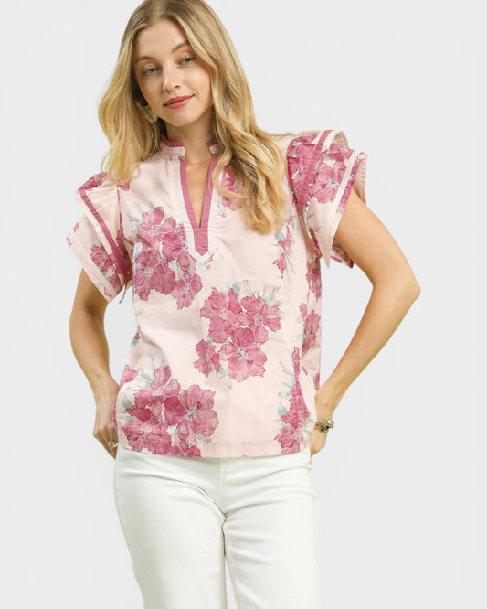 Woman wearing a pink floral blouse on a white background