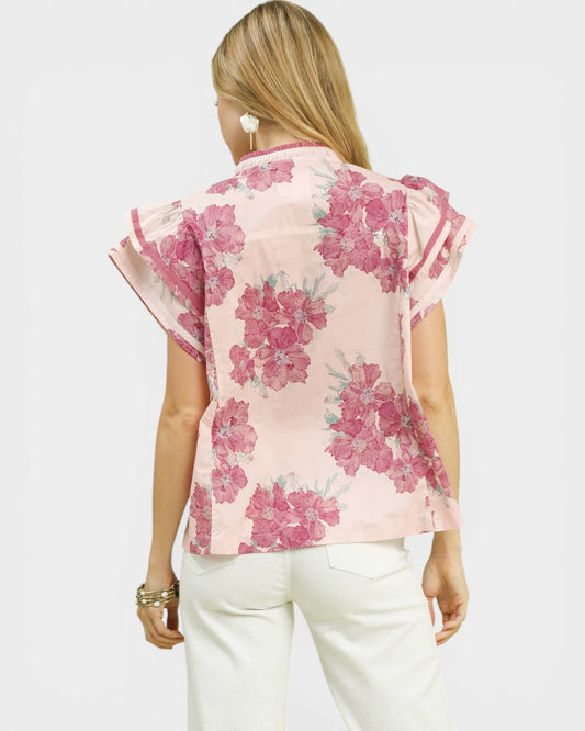 Woman wearing a pink floral blouse on a white background