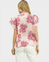 Woman wearing a pink floral blouse on a white background